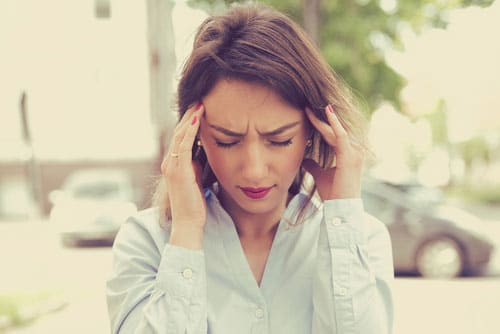 photo of young woman standing outdoor stressed and sad