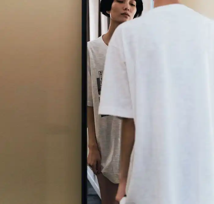 a woman looking at the mirror struggling from anorexia