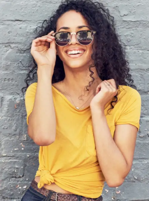 young lady wearing yellow shirt feeling good after recovery at drug rehab in orange county california