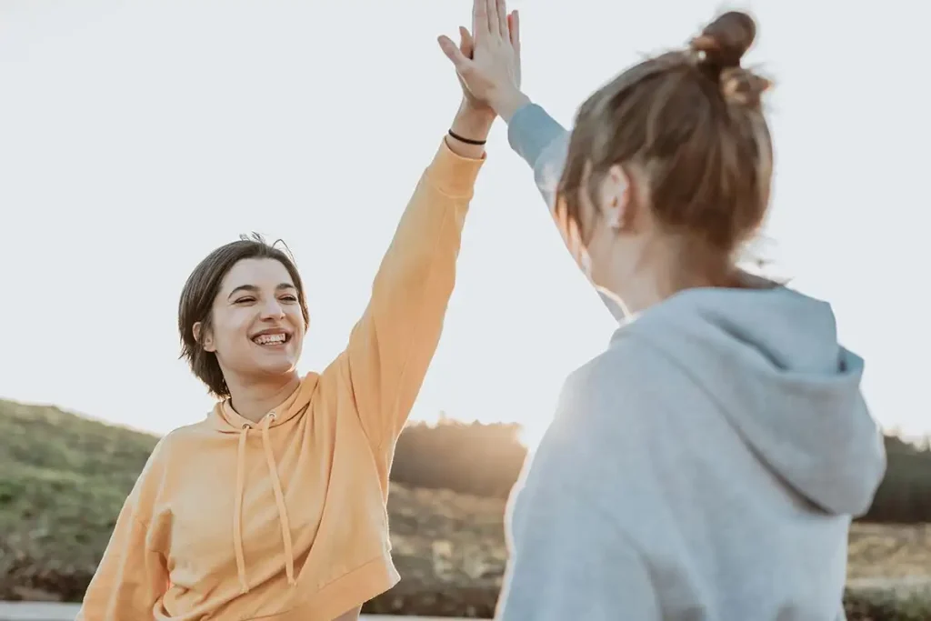 two women celebrate their addiction recovery journey together