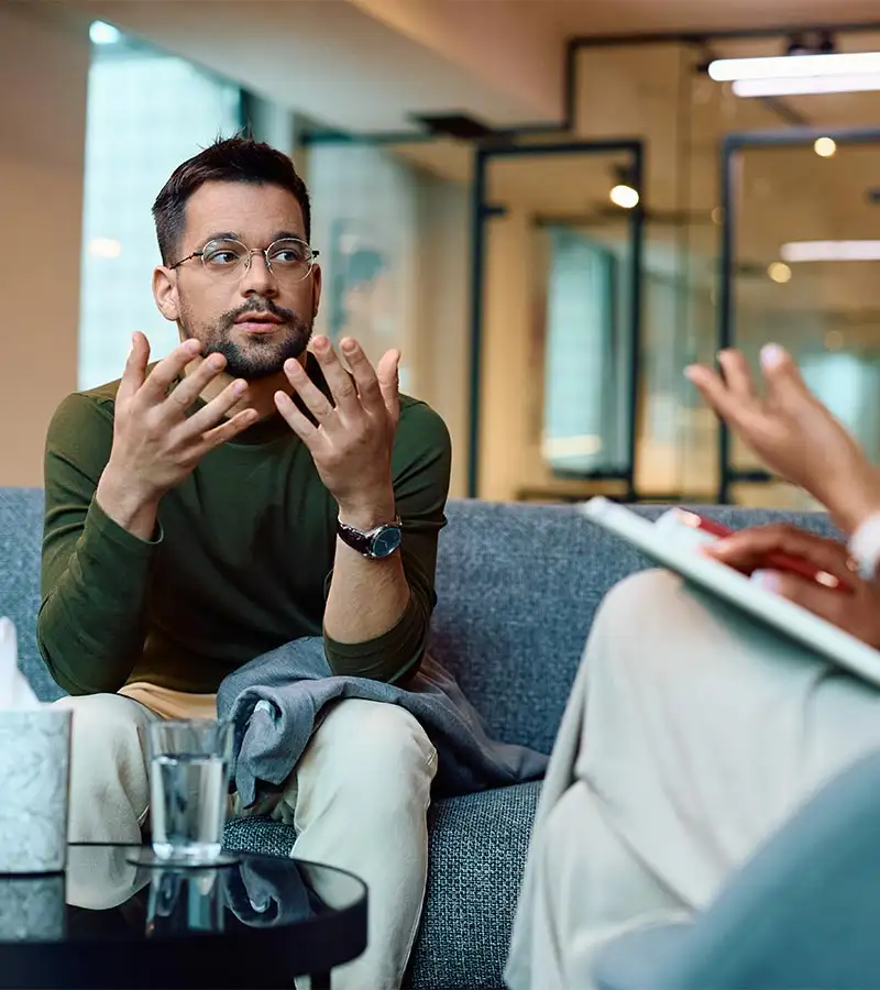 a man with a therapist during Hallucinogen abuse treatment one on one therapy concent in california